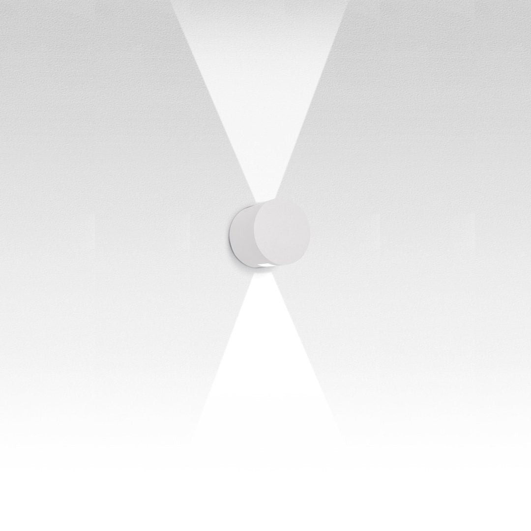 Minimalist white wall fixture with a smooth circular design, featuring a subtle gradient and clean lines.