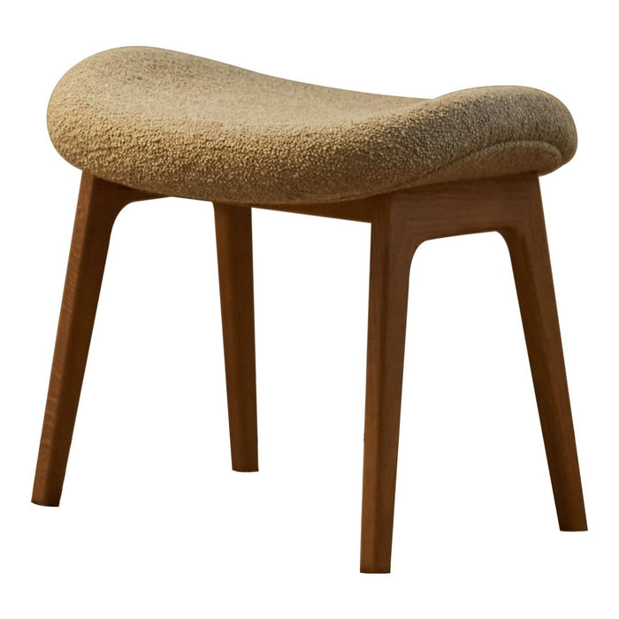 Beige textured upholstered stool with wooden legs, featuring a smooth, curved silhouette. Perfect for modern decor.