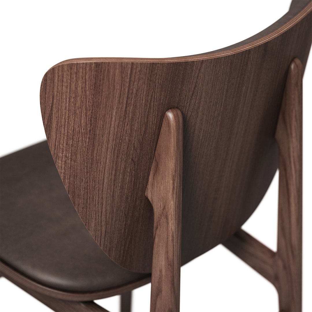 Walnut wood chair with curved backrest and dark leather seat, showcasing natural grain patterns and rich, warm tones.