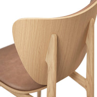 Minimalist chair featuring a light wood back and a cozy brown leather seat for a modern aesthetic.