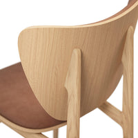 Wooden chair with a light oak finish and a rich brown suede seat, featuring smooth curves and minimalist design.