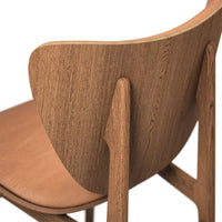 Wooden chair with a natural oak finish and smooth, minimalist design featuring subtle grain patterns.