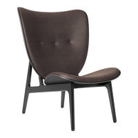 Brown upholstered accent chair with a smooth finish and subtle button detailing on a sleek black frame.