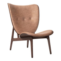 Brown suede lounge chair with a smooth, curved design and wooden legs, featuring subtle button accents.