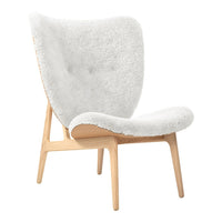 White, plush chair with a tufted design and natural wood legs, combining modern elegance with cozy comfort.