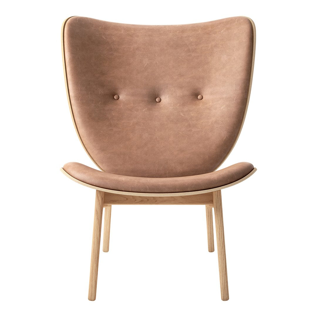 "Soft brown upholstered chair with a smooth texture and minimalist design, featuring two button accents."