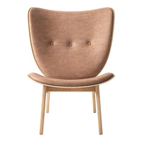 "Soft brown upholstered chair with a smooth texture and minimalist design, featuring two button accents."