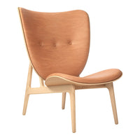 Tan leather armchair with a minimalist design and natural wood legs, featuring smooth curves and a button tufted back.