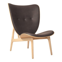 Mid-century modern chair in dark gray upholstery with wooden legs and minimal button tufting. Elegant and versatile design.
