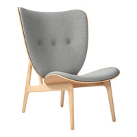 Gray upholstered chair with a sleek, modern design and light wood accents, featuring button detailing.