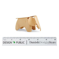 Light wood elephant figurine with smooth finish, showcasing natural grain and simple design. Perfect for decor or gifting.