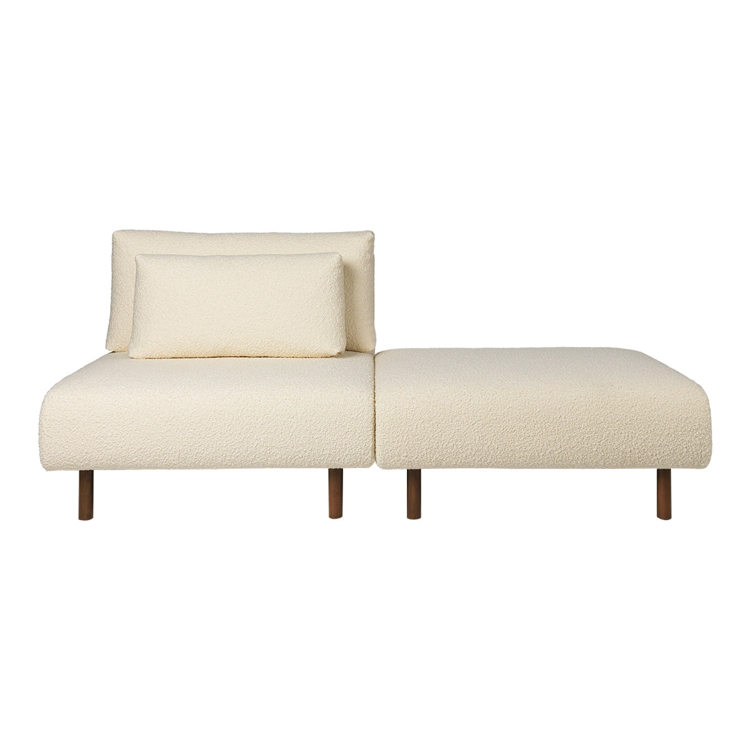 Cream upholstered sofa with a minimalist design and contrasting wooden legs, featuring a simple, smooth pattern.