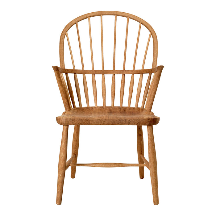 Natural wood chair with a light honey tone and classic spindled back design. Simple, elegant, and warm aesthetic.