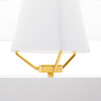 Gold geometric lamp base with a white fabric shade, creating a modern and stylish contrast.