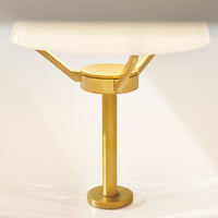 Gold table lamp base with a sleek white lampshade, featuring a modern minimalist design and smooth lines.
