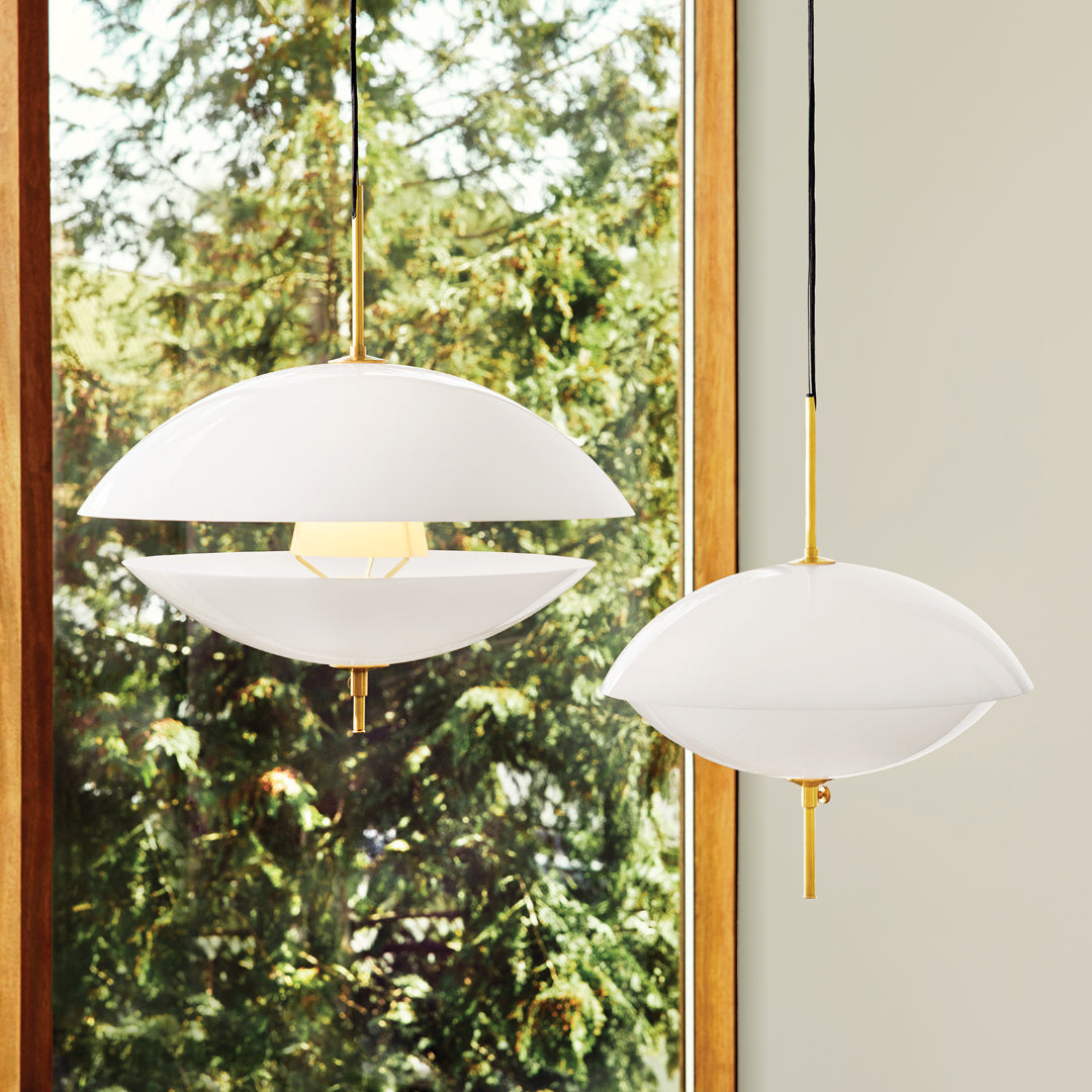 Modern white pendant lamps with sleek gold accents, featuring a smooth, rounded design and minimalistic style.