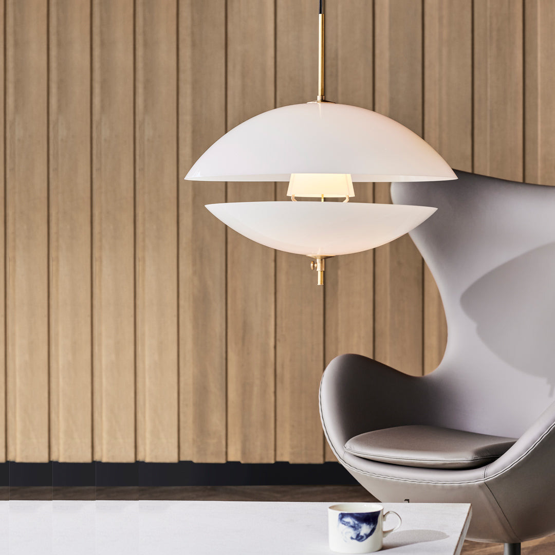 Modern white pendant lamp with sleek curves, set against a warm wooden backdrop. Chic and minimalist design.