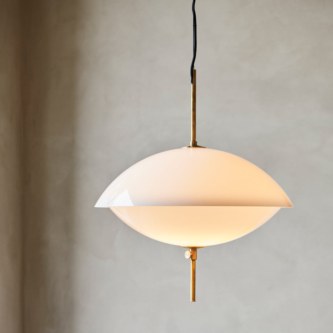 Elegant cream pendant lamp with a sleek rounded design and gold accents, perfect for modern decor.