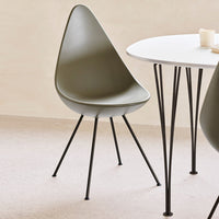 Olive green modern chair with a minimalist design, set against a light beige background and black metal legs.