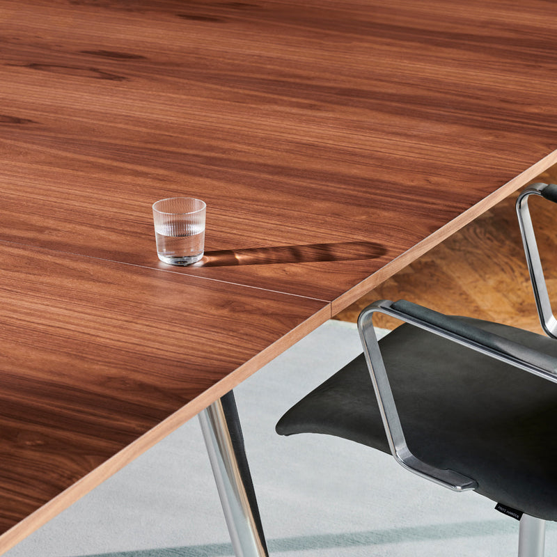 Wooden table featuring rich brown tones and a smooth, polished surface, complemented by sleek silver accents.