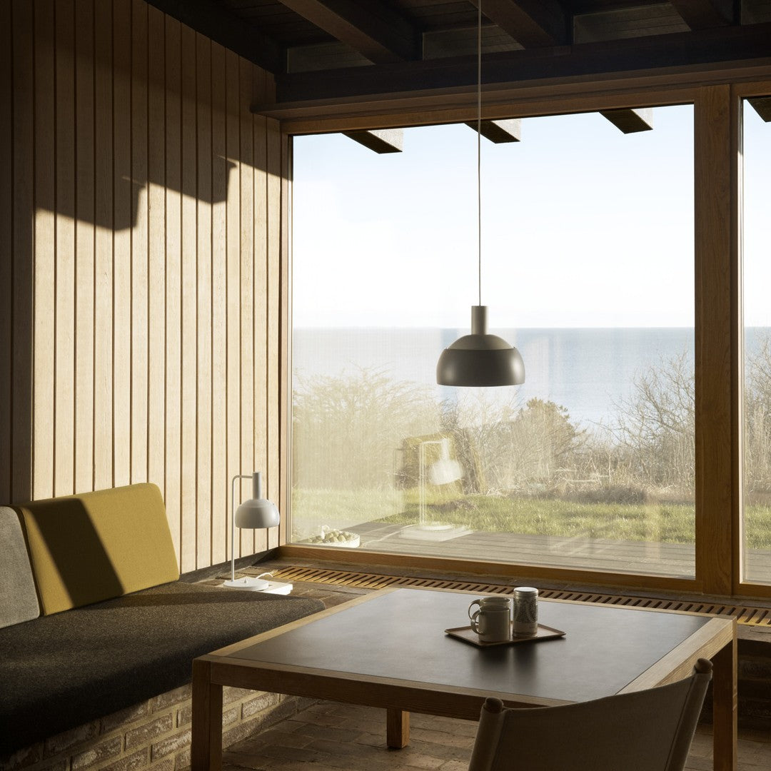 Modern interior with a sofa, coffee table, and large window view.