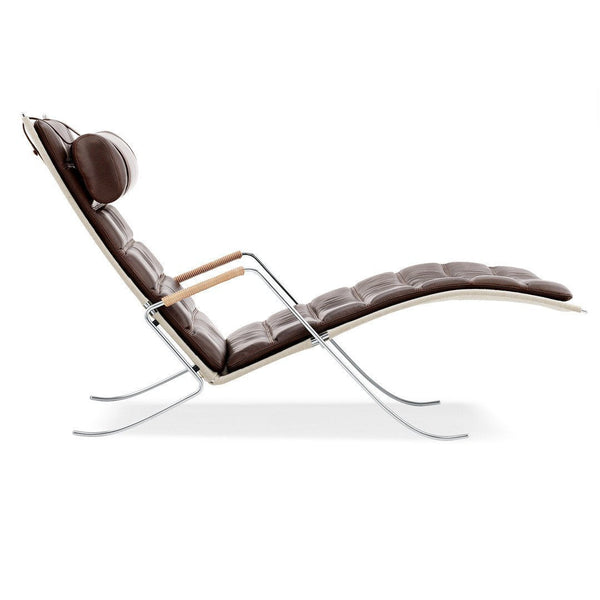 "Modern brown leather chaise lounge with subtle tufted pattern and sleek chrome accents."
