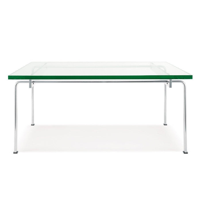 Clear glass table with a green edge and sleek chrome legs, featuring a minimalist design.