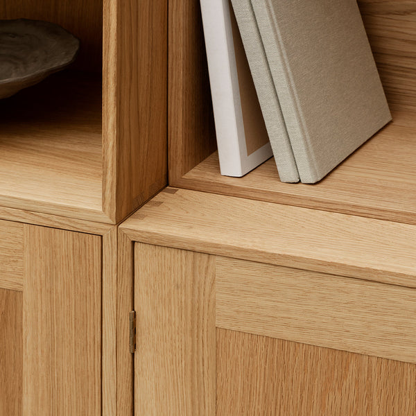 Natural oak wood finish with smooth grain pattern, featuring minimalist design and neutral book colors.