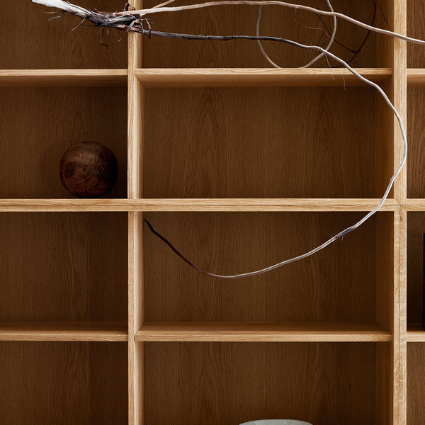 Wooden shelving unit with light oak finish, minimalist design, featuring natural wood tones and smooth surfaces.