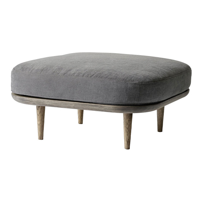 Gray upholstered ottoman with a smooth surface, featuring wooden legs and a minimalist design. Perfect for modern interiors.