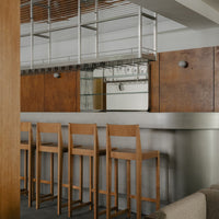 Modern kitchen with warm wood tones, sleek stainless steel, and minimalist design. Ideal for contemporary spaces.
