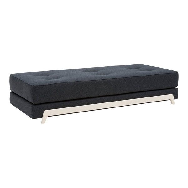 Black tufted sofa upholstered in a sleek fabric, featuring a modern silver base and minimalist design.