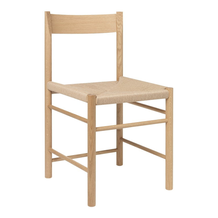 Natural wood chair with a light beige woven seat and simple, minimalist design. Perfect for modern decor.