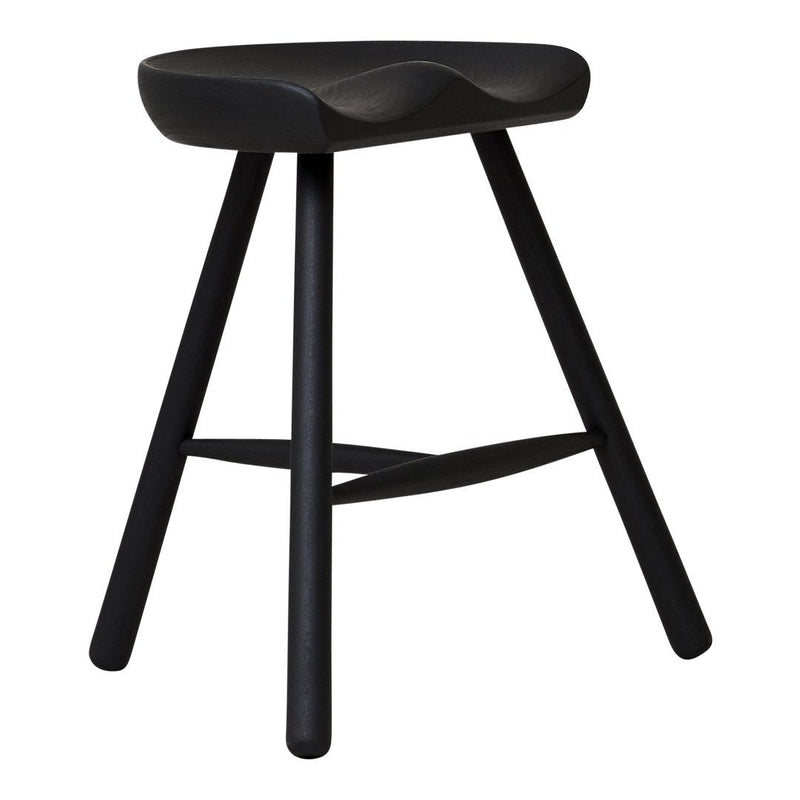Black wooden stool with a smooth, curved seat and minimalist design, featuring slender, tapered legs.