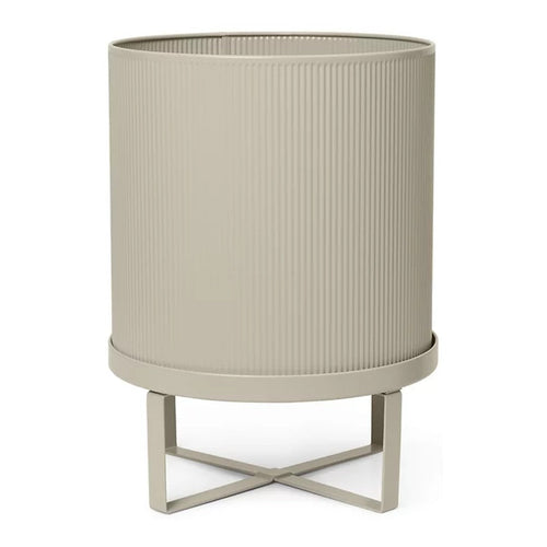 "Neutral beige planter with ribbed texture and minimalist metal stand."