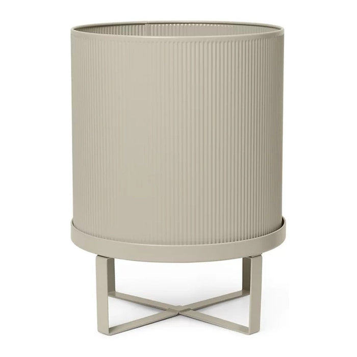 "Neutral beige planter with ribbed texture and minimalist metal stand."