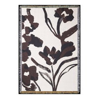 Floral-patterned rug with bold brown designs on a cream background, featuring fringed edges for added texture.
