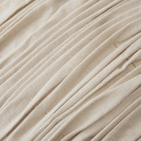 Beige pleated fabric with a textured surface, featuring subtle variations and a natural, organic look.