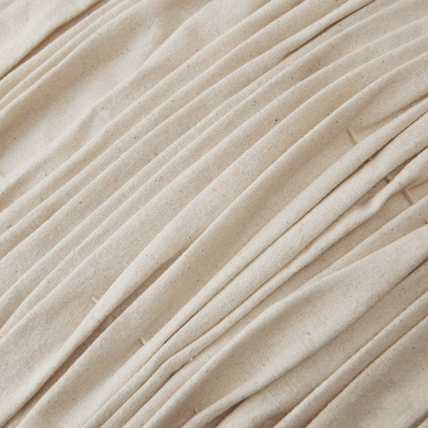 Beige pleated fabric with a textured surface, featuring subtle variations and a natural, organic look.