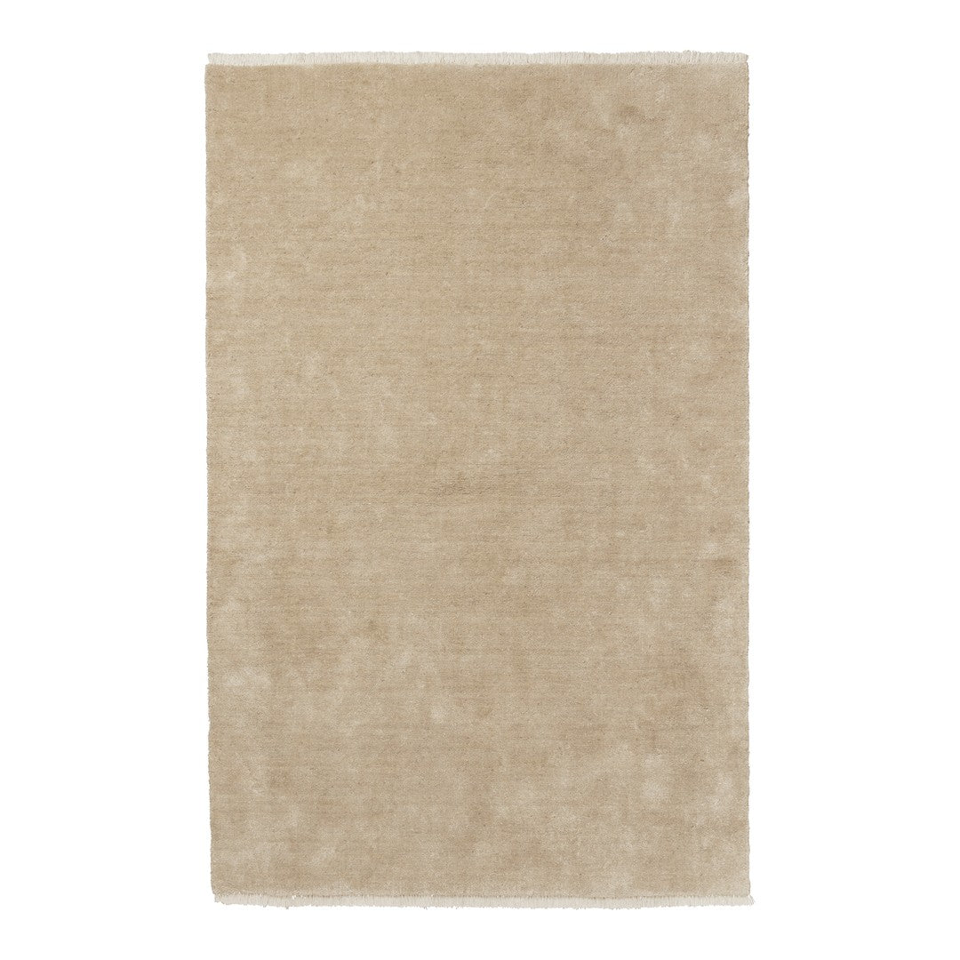 Soft beige area rug with a subtle texture and no visible patterns, perfect for versatile home styling.