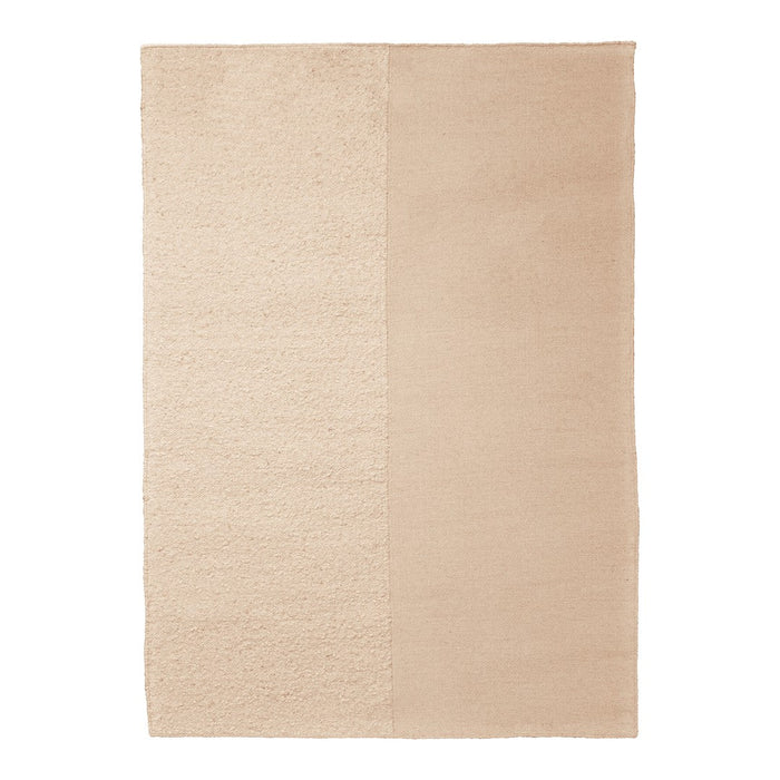 Beige area rug with a textured pattern, featuring smooth and plush sections in complementary tones.