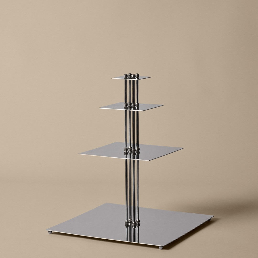 Shiny silver display stand with sleek square shelves, set against a soft beige background. Perfect for modern decor.