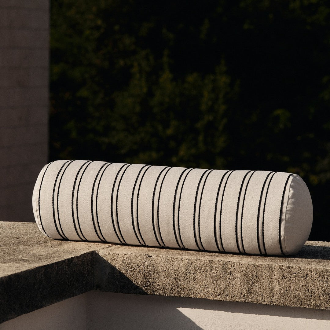 Striped bolster pillow in cream and black, featuring evenly spaced vertical lines for a modern touch.
