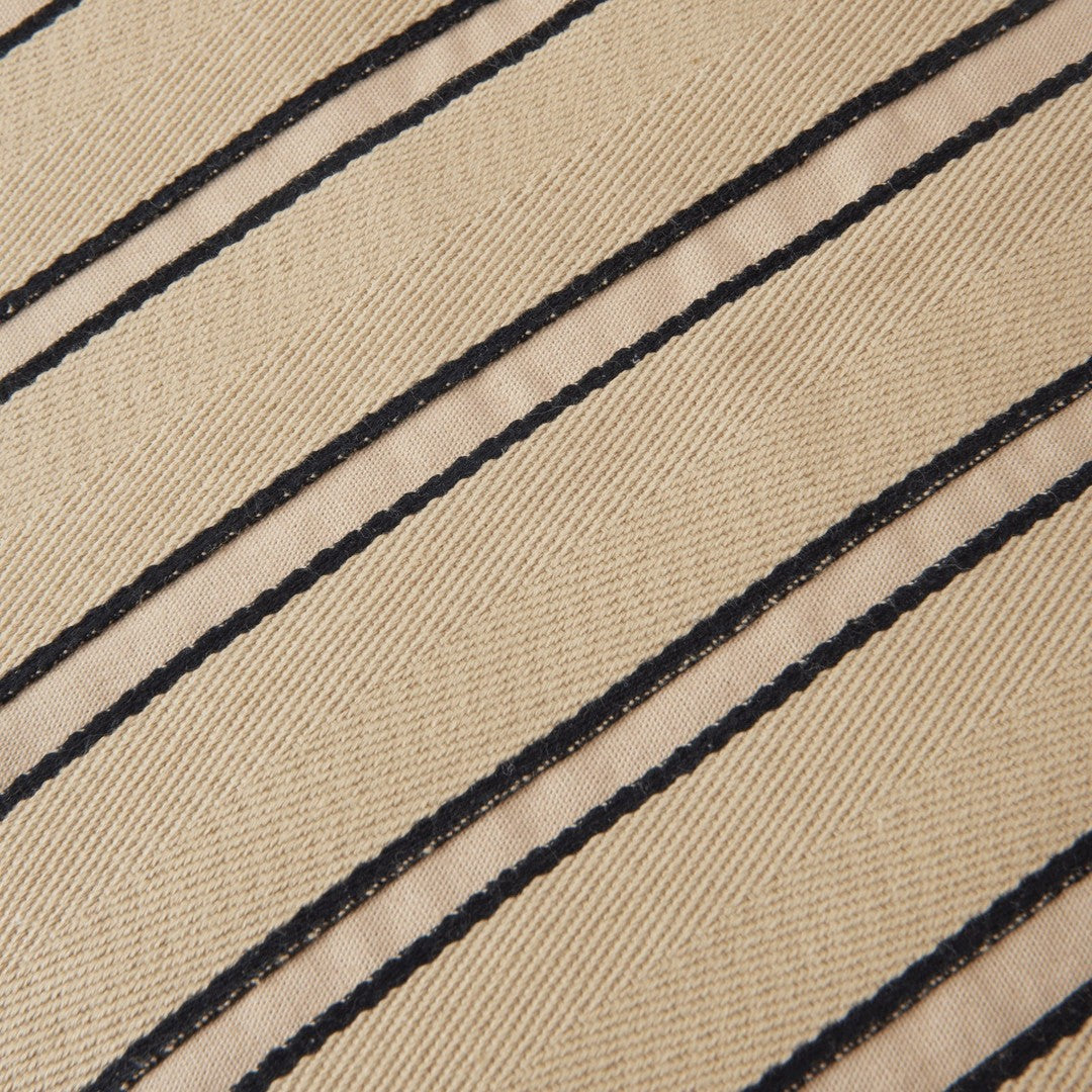 Beige fabric with bold black stripes creating a textured pattern, perfect for stylish accents.