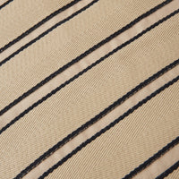 Beige fabric with bold black stripes creating a textured pattern, perfect for stylish accents.