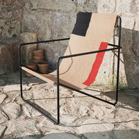 Natural beige chair with bold black and red geometric patterns, featuring a sleek black metal frame.