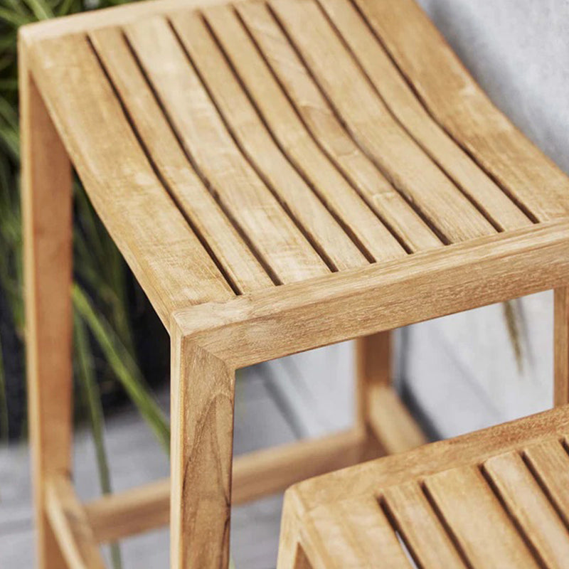 Light wooden stool with a slatted design, featuring natural tones and smooth finish for a stylish look.