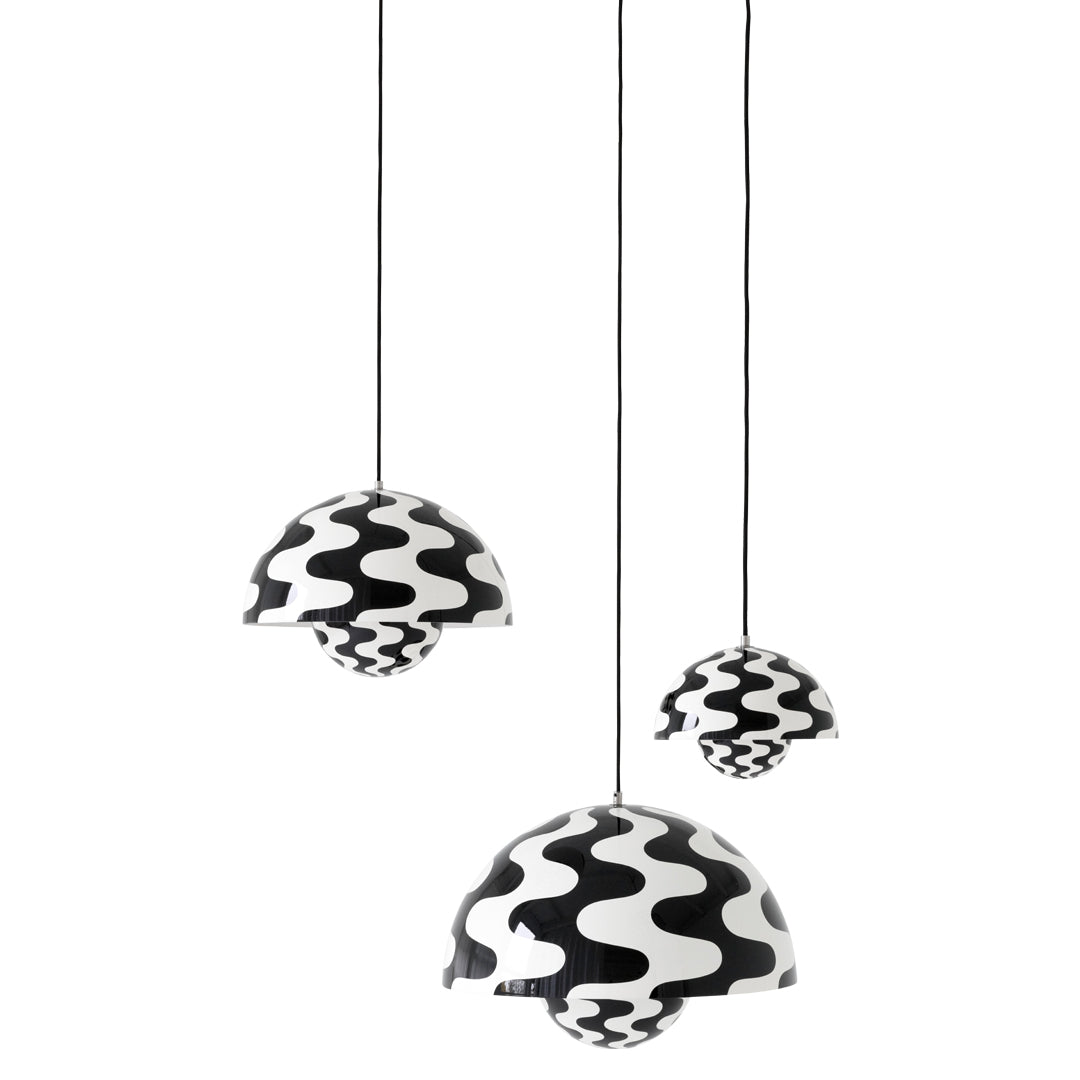 Black and white pendant lamps with wavy patterns, featuring three varying sizes for a stylish, modern accent.