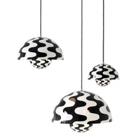 "Black and white pendant lamps featuring wavy pattern design, adding a modern touch to any space."