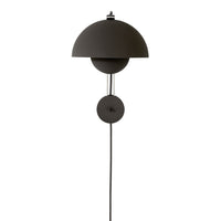 Black minimalist wall lamp with a sleek dome shade and circular base. Perfect for modern decor.